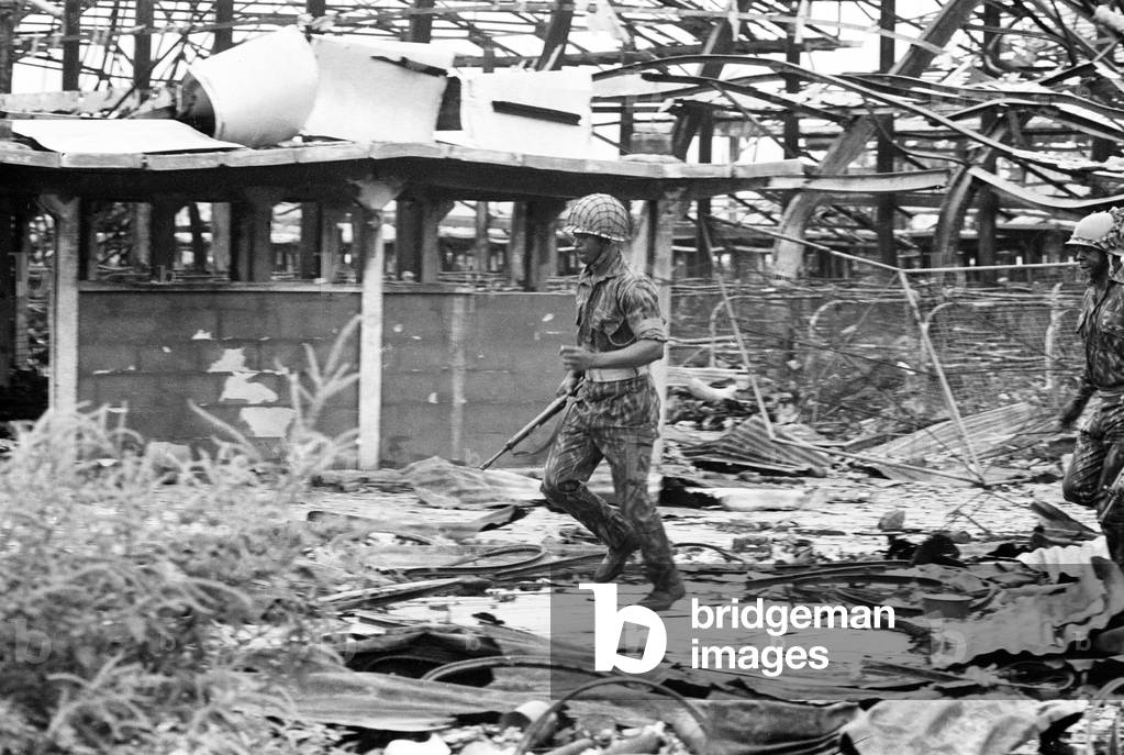 Pictures taken during the Daily Mirror's attempt to reach the refugee camps of Onitsha and Asaba during the Biafra conflict.
Picture shows a soldier inspecting the ruins of Onitsha market place after it was blown and gutted during fighting for the town.
16th July 1968.