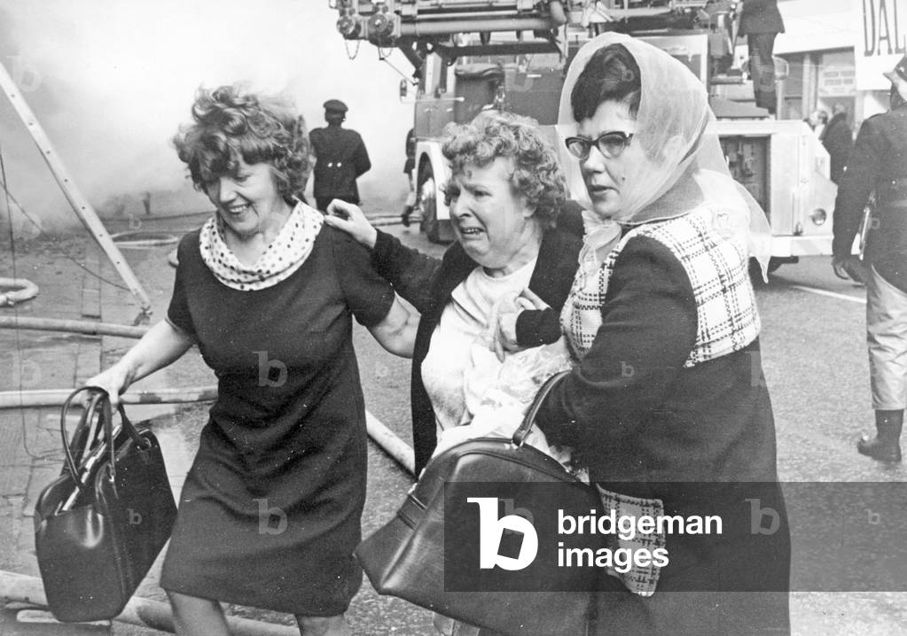 Fire at Maryhill Road Glasgow. Fire breaks out in an unoccupied furniture shop spreading along the row of shops and trapping some families in their homes above. Fifty families were made homeless and one woman and one Fire Officer lost their lives. Saturday, 18th November 1972 (b/w photo)