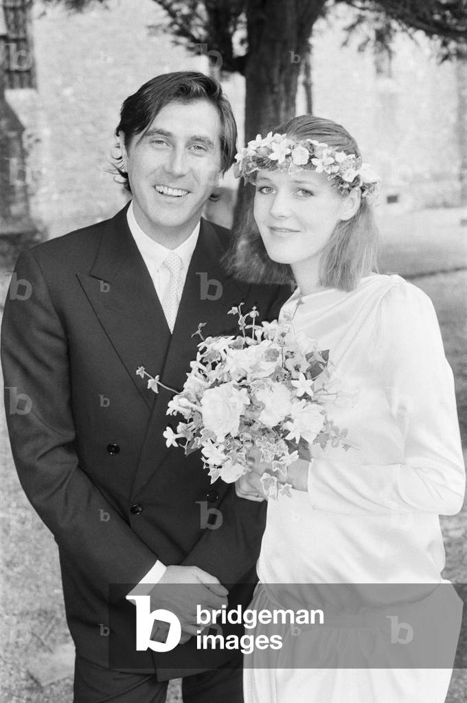 Bryan Ferry poses with his bride, Lucy Helmore, after their wedding ceremony at Duncton, West Sussex, 26th June 1982 (b/w photo)