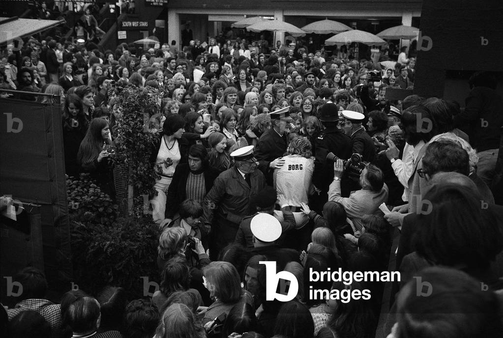 Tennis star Bjorn Borg escorted from screaming fans at Wimbledon 1974 (b/w photo)