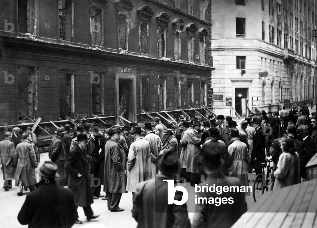 Business men from bombed out offices gather in the street to transact business. 13th May 1941 (b/w photo)