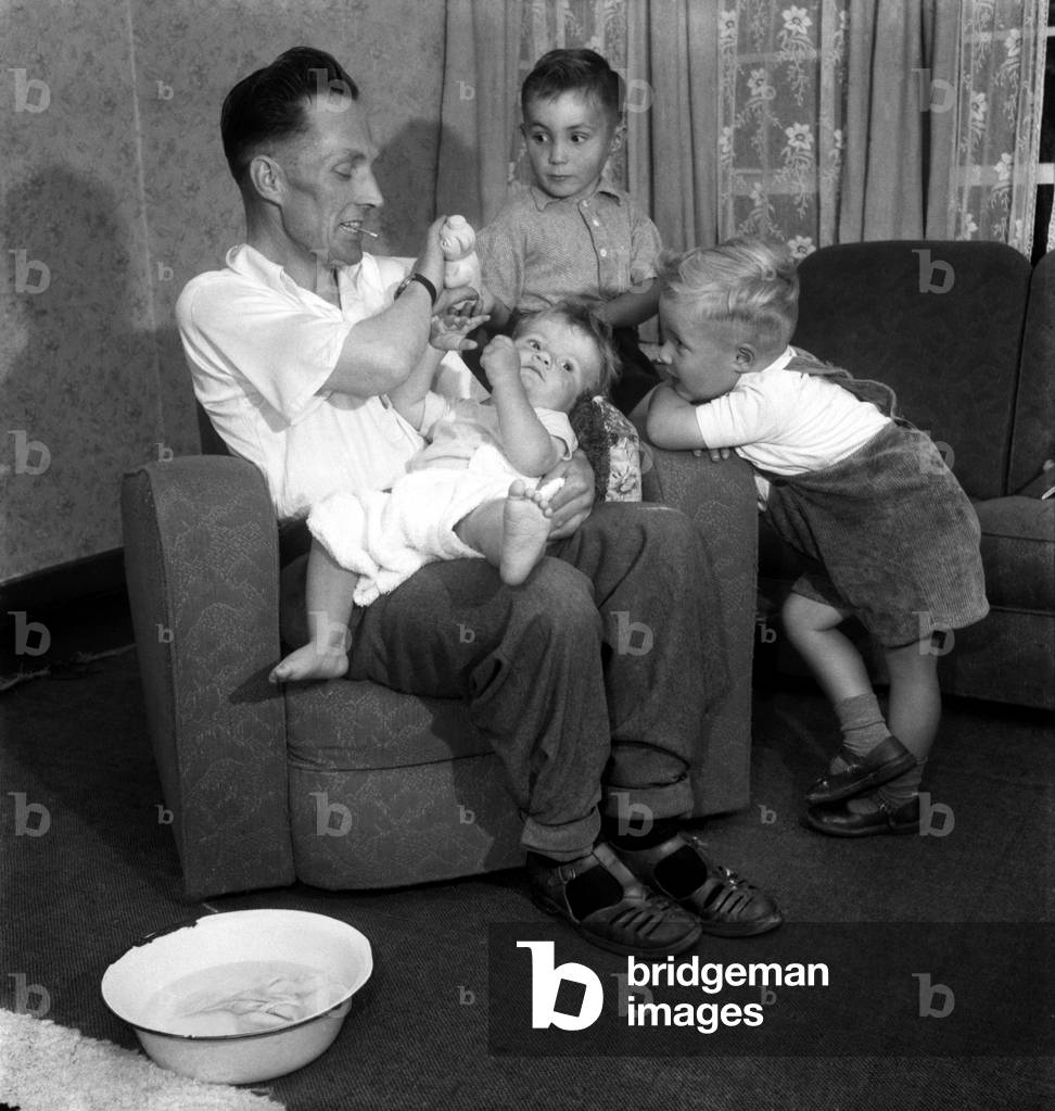 The Sunday Pictorial School for Fathers, where the training includes changing Nappies, preparing feed bottles and playing with the children. 
June 1953 
D3526