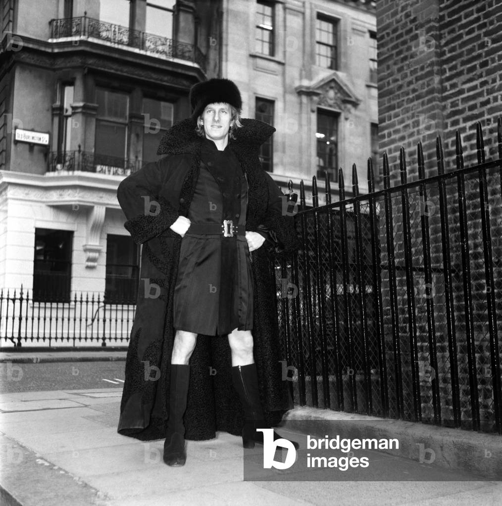 People Men Humour. Fashion Clothing. Mr. Fish wearing a full-length leather maxi coat, October 1969 (b/w photo)