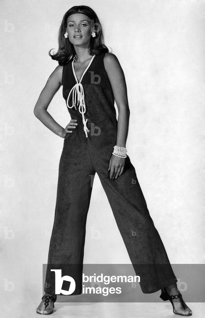 Bright blue towelling jumpsuit, trimmed with white at the V-neck and with white cord lacing up the front. By Jersea of Sweden. 
May 1969