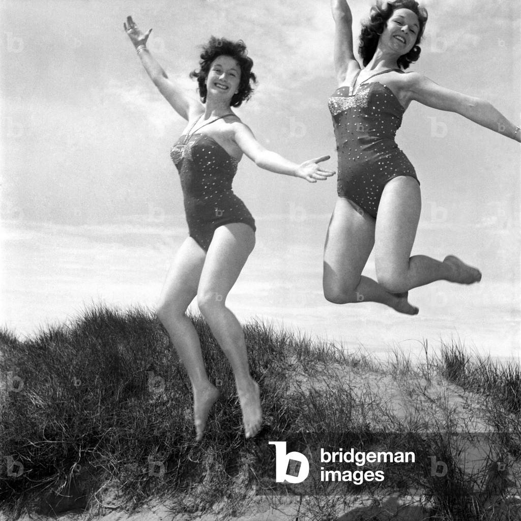 Glamour showgirl. You just can't keep showgirls Lynn Paton and Vera Williamson, of Southport Lancs. away from the beach. June 1960 M4283-005
