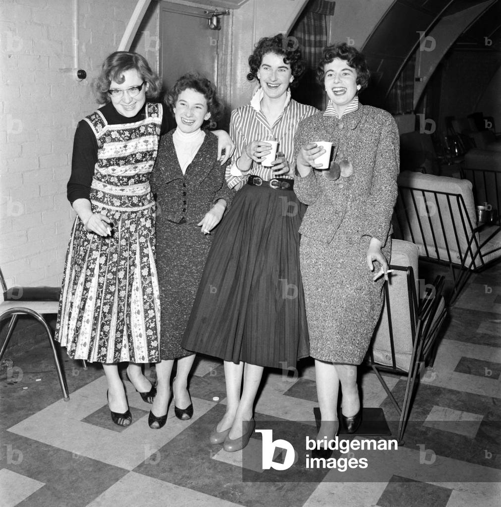 Americans in the U.K.: Americans at the air base at Wethersfield, Essex seen here relaxing at the PX with a group of Essex girls, 1955 (b/w photo)