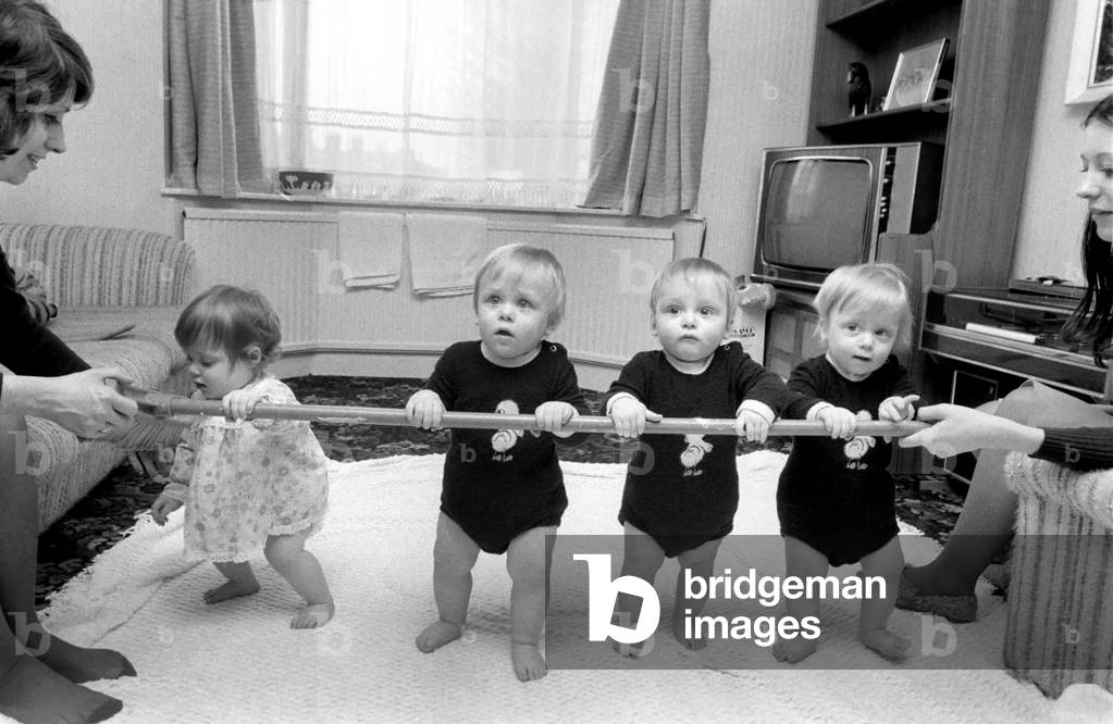 Babies. Massey Quads. Now we are nearly one. Last Easter the Massy Quads hit the headlines when they were born in St. Mary's Hospital, Paddington. Gordon, Deborah, Richard and Andrew, March 1975 (b/w photo)