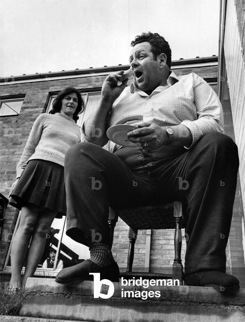 Portly Peter, precariously perched, nibbles a slimming biscuit. Beside him is his wife Kate. She's trying to put weight on. 
May 1971