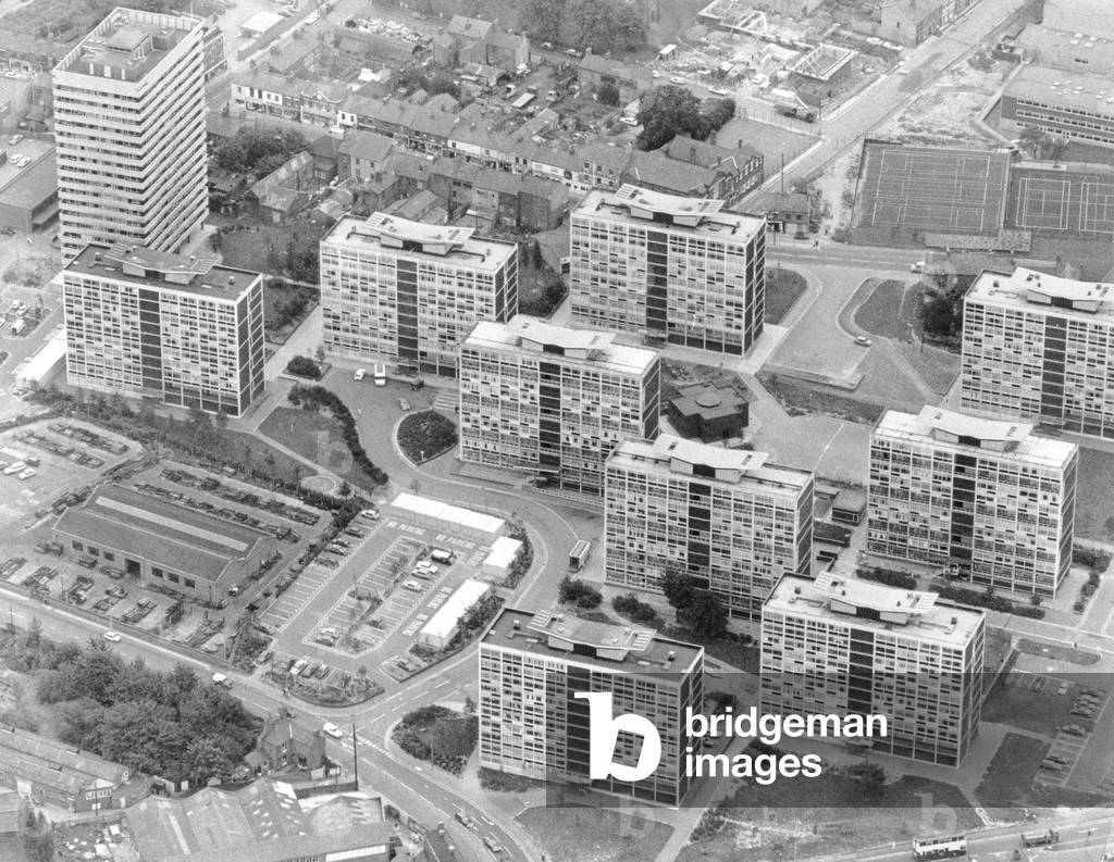 The short and tall of the Hillfields landscape. Gone are the row-upon-row of terraced houses that once formed the heart of the area and in their place have sprung up great towering blocks of flats. Now the shops of Victoria Road look out of place with the monsters on their doorsteps. 23rd August 1974 (b/w photo)