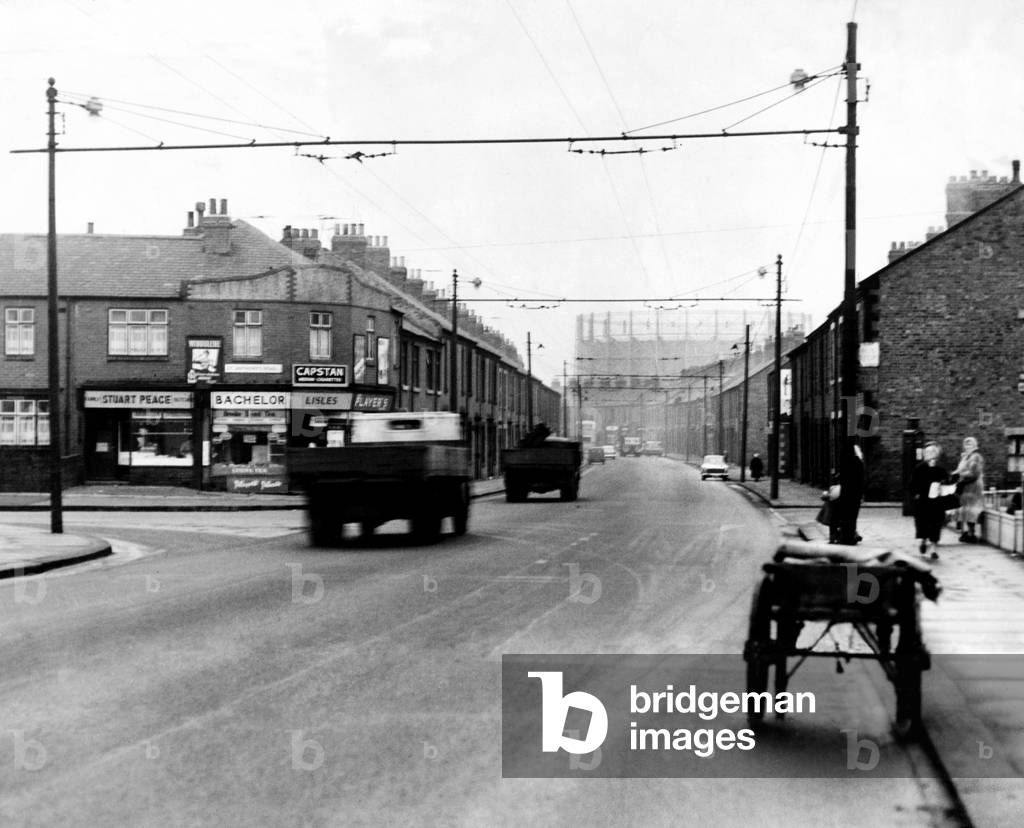 A view of Walker Road, Walker, Newcastle upon Tyne, Tyne and Wear. Visible in the background is a gas holder. 16th January 1961 (b/w photo)