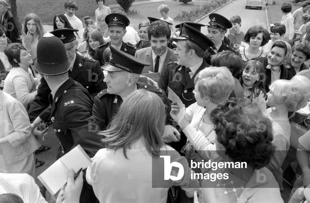 Welsh singerTom Jones visited Corley Residential School's garden fete in Coventry and was presented with a silver tankard. The money raised at the fete will go to building a swimming pool at the school for delicate children. 10th June 1967 (b/w photo)