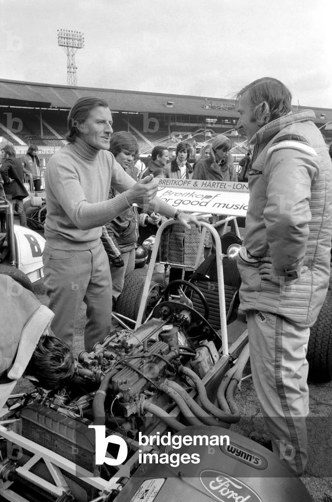 Mini Grand Prix, White City Stadium, Graham Hill sorting out a few performance problems, March 1975 (b/w photo)