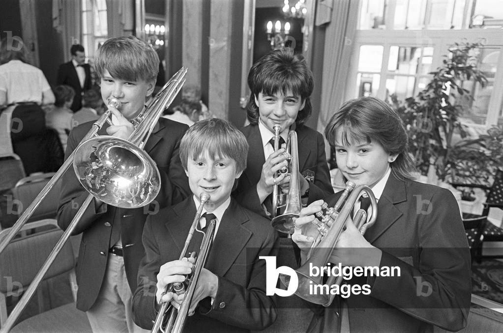 Huddersfield Youth Band members (from left) Andrew Varley, Tom Lowe, Joanne Thompson and Alison Varley provided the music at a Yorkshire evening at the George Hotel. Among guests at the speciality event were Bill Owen and Peter Salis - Compo and Clegg from television's 'Last of the Summer Wine' and the programme's newest member, Michael Aldridge, who plays Seymour Otterthwaite. They were served traditional Yorkshire dishes named after places and characters from the Huddersfield area. 31st May 1985 (b/w photo)