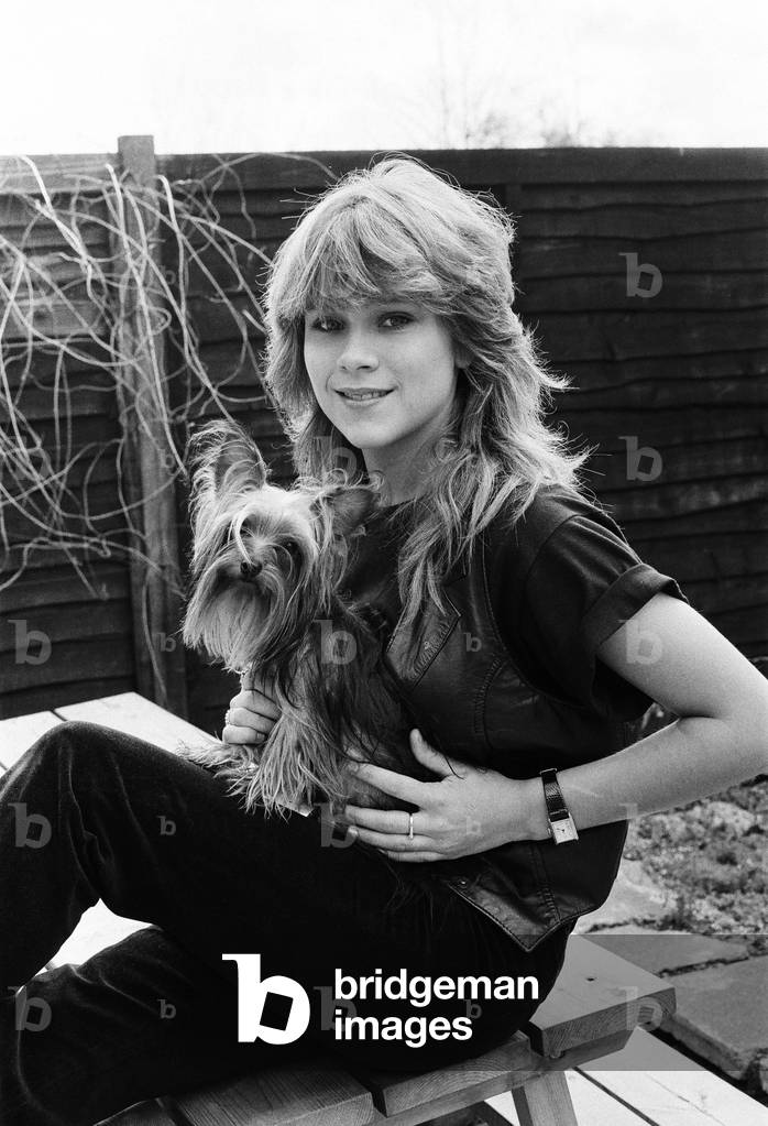 Samantha Fox contestant Miss Sunday People competition, aged 16 years old, pictured with pet dog at home January 1983 (b/w photo)