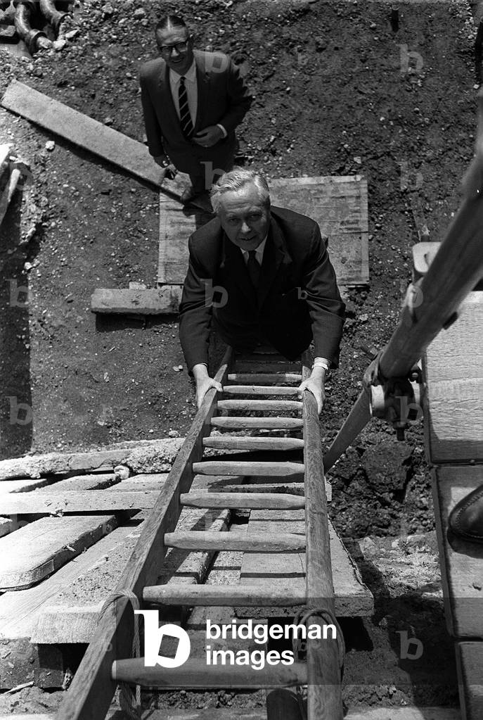Harold Wilson climbs a builders ladder during a visit to Toynbee Hall in the procsess of being built 1965