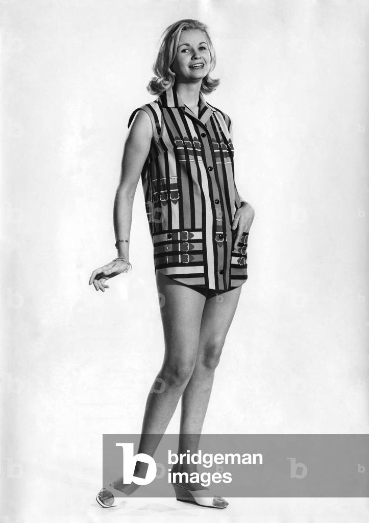 Woman wearing sleveless shirt. July 1961