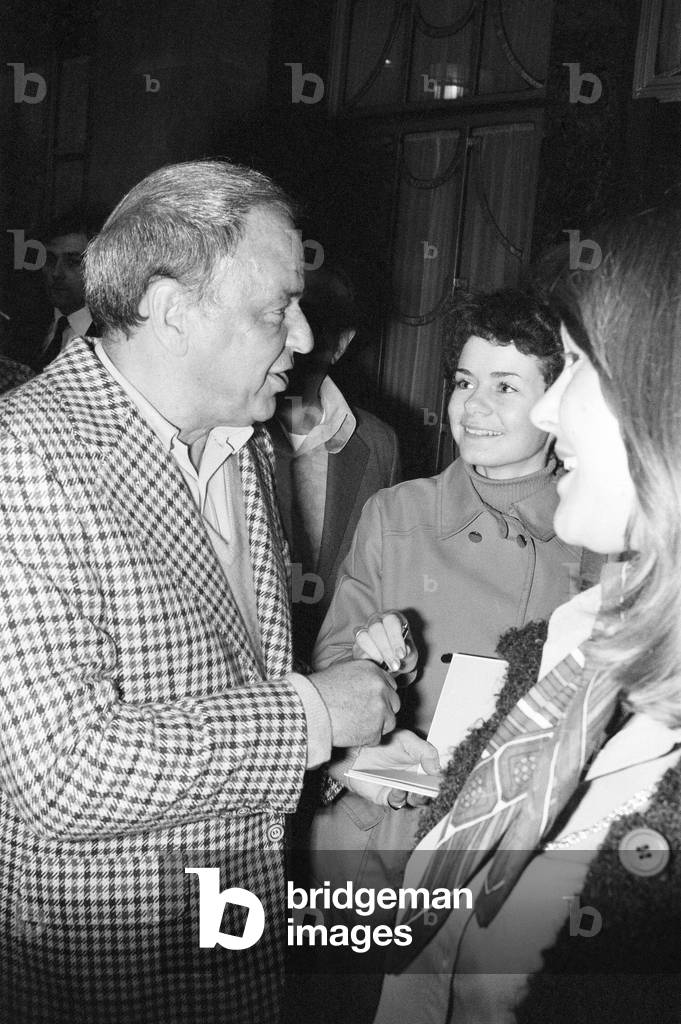 Frank Sinatra, in London for the European Leg of his farewell tour,pictured signing autographs outside Claridge's Hotel, London, 17th May 1975.