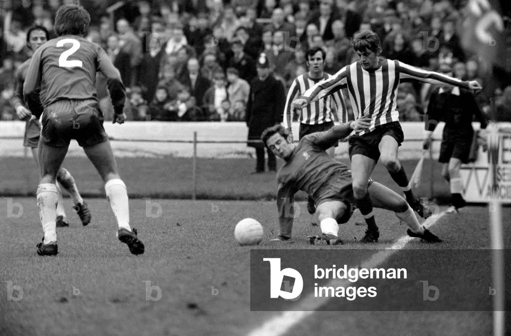 English League Division one match. Chelsea 3 v Southampton 1. John Hollins slide tackles Tom Jenkins. December 1969 (photo)