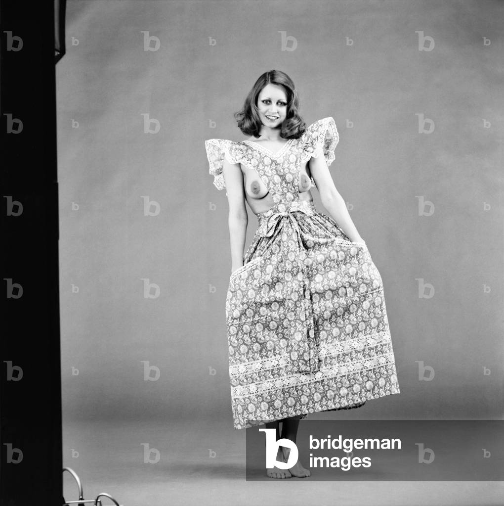 Glamour girl Geraldine June wearing a pinafore. 
January 1975