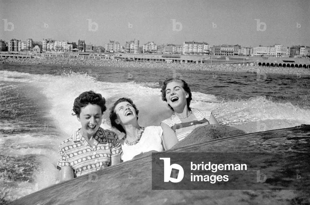 Three women were bounced and soaked as each big wave drenched them whilst on a high speed boat ride on the sea at Brighton, 12th August 1953 (b/w photo)
