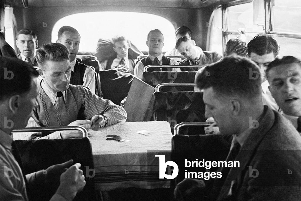 The Derby County team return home with the FA Cup trophy following their victory over Charlton Athletic in the Final at Wembley. Picture shows: members of the team playing cards in the coach on the way back to Derby. 1st May 1946 (photo)