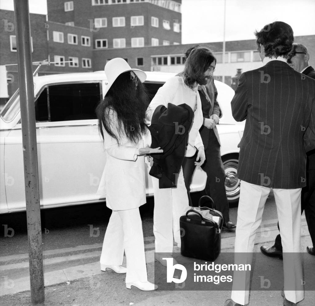 Beatles singer songwriter John Lennon and wife Yoko Ono pictured at Heathrow today. April 1969 (b/w photo)