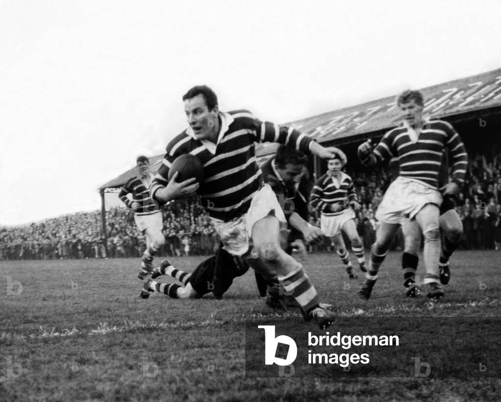 Featherstone Rovers v. Australia. Loose forward Don Fox bulldozes his way across the line for the home team's third try, which, when converted, gave Featherstone a 19-12 lead over the tourists. October 1963 (b/w photo)