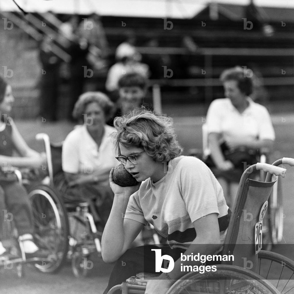 Paralympic Athletes training at Stoke Mandeville, watched by patients, ahead of the 1964 Paralympics to be held in Tokyo, pictured 22nd July 1964 (b/w photo)