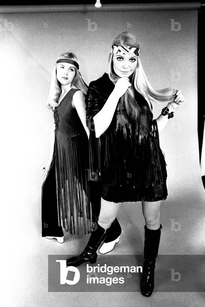 Models wear dresses with knee length boots for a fashion shoot, 13th April 1970 (b/w photo)