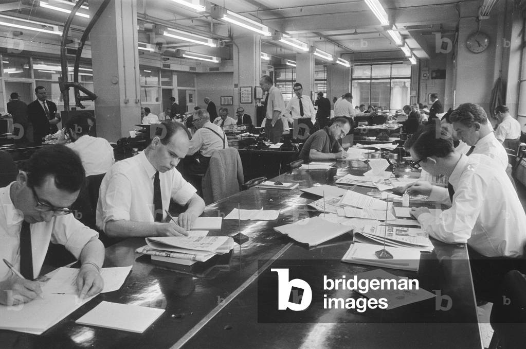 Busy scenes on the Daily Herald news desk, 1964 (b/w photo)