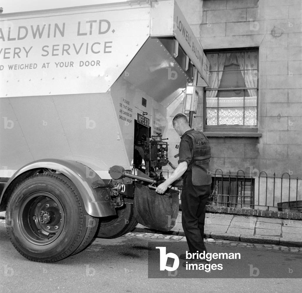 Bristol coal delivery, coal man weighs out delivery, c. 1957 (b/w photo)