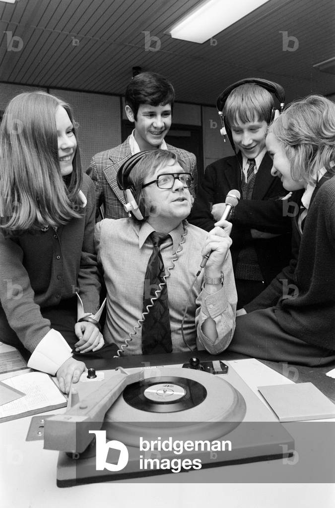 Ed Doolan BRMB Radio Disc Jockey, pictured with news boys and girls, Birmingham, 14th January 1975 (b/w photo)