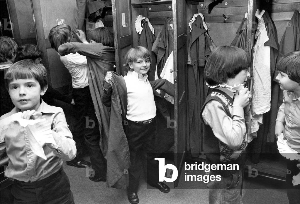 There is a controlled scramble as the boys get into their surplices and collars ready to troop out to the choir stalls of St. Nicholas Cathedral in Newcastle on May 26, 1980 (b/w photo)