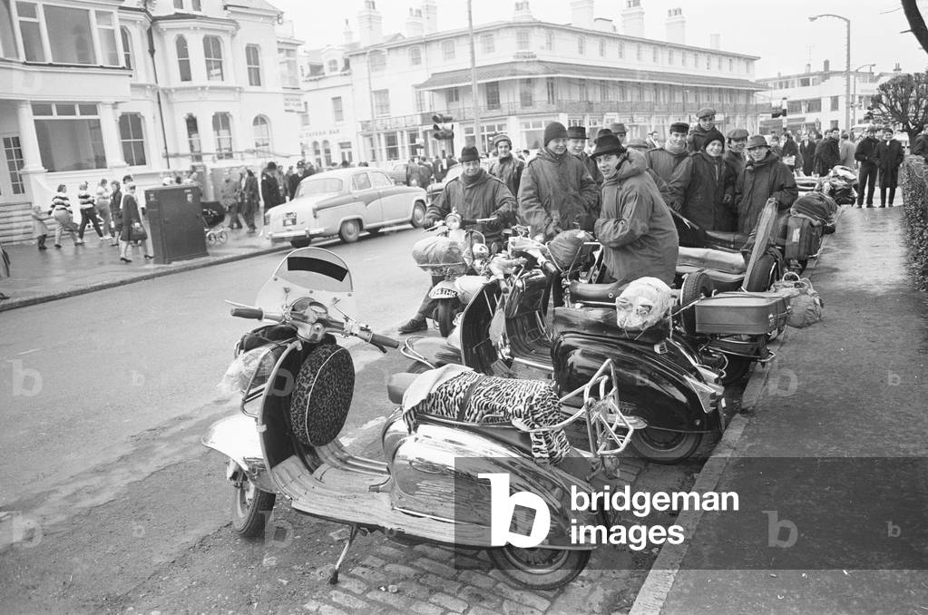 Mods with their scooters gather on Clacton sea front over the Easter weekend, 30th March 1964 (b/w photo)