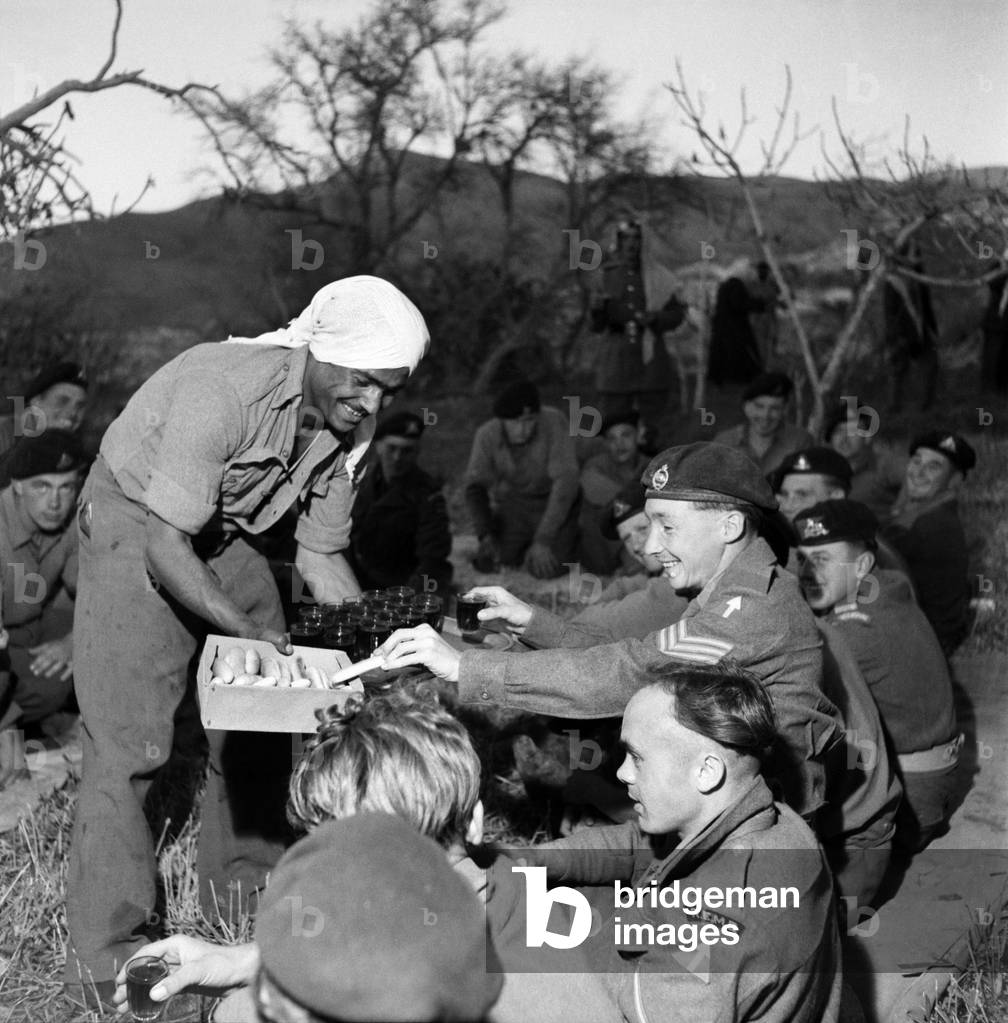 British soldiers and local Arab men enjoy a feast in Jordan. March 1952 C1287-002