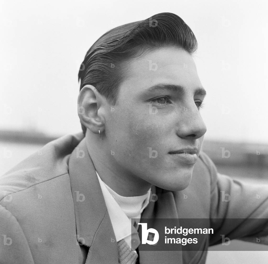 Ray Winney, 16, shows off his earring. 'Dockside Dandies' at Lowestoft, Suffolk. 16th May 1962 (b/w photo)