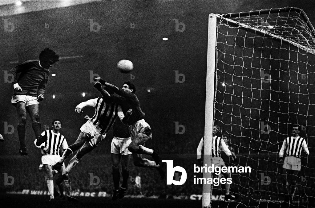 Manchester United footballer George Best in action to score his second goal with a header past West Bromwich Albion goalkeeper John Osborne during the League Division One match at Old Trafford. 2nd December 1967 (photo)