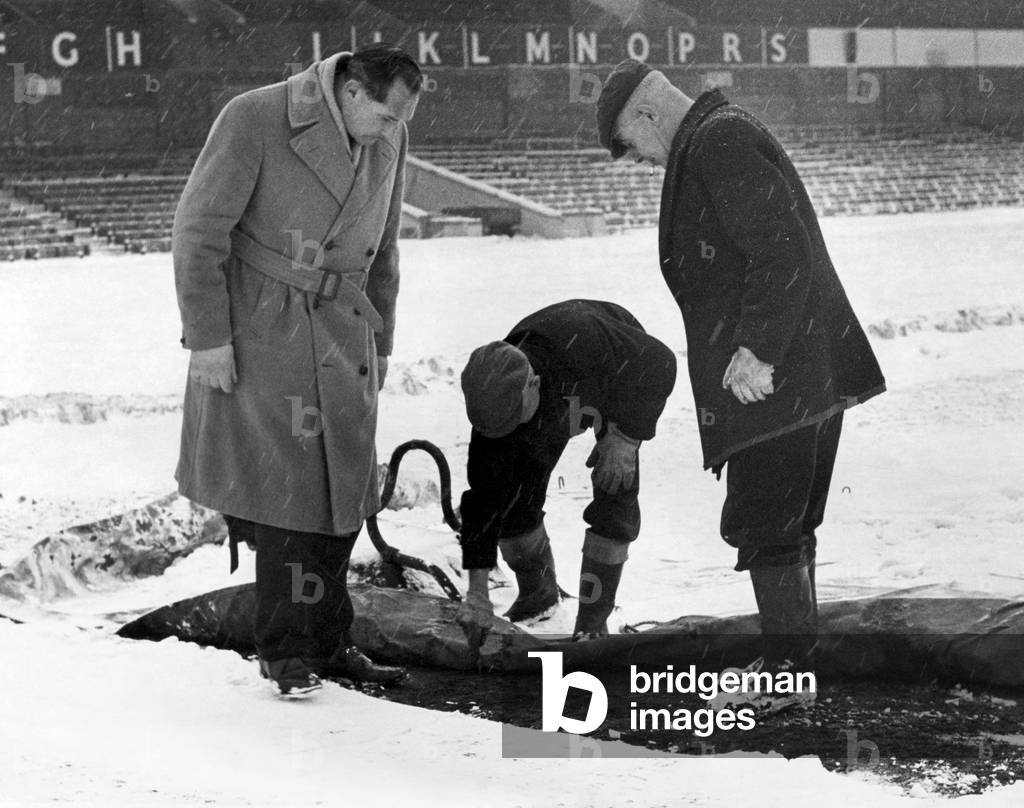 Birmingham City manager Gil Merrick (left) takes a close look at the St Andrews pitch as they prepare for a league fixture at the ground. 28th December 1962 (photo)