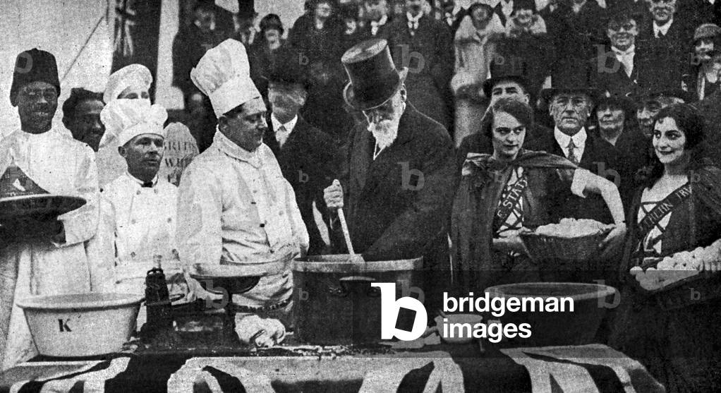 Lord Meath, Reginald Brabazon, 12th Earl of Meath pictured stirring ingredients for the ceremonial Empire Christmas pudding, which King George V has consented to receive from the Empire Day movement. Adelaide House, London Bridge, London, 1st December 1927 (b/w photo)