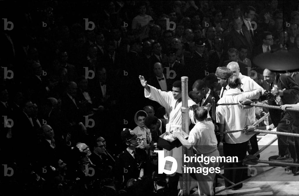 Heavy weight championship of the World bout between Cassius Clay v. Brian London at Earls Court: Clay is seen here waving to his fans leaving the ring after beating London , August 1966 (b/w photo)