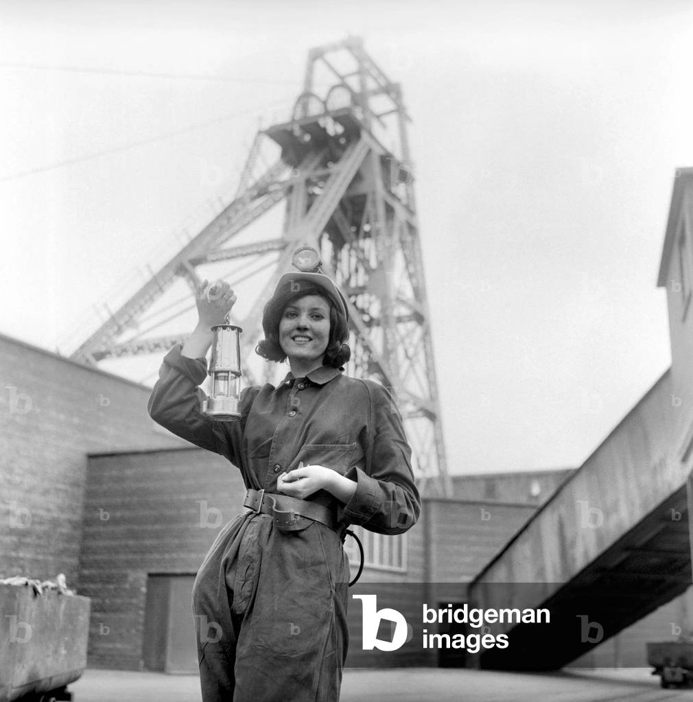 Coal Queen Arlene puts a stop to swear-words at the coal face. The 1,800 pitmen at a Yorkshire colliery were on their best behaviour yesterday-for they were hosts to a coal queen. Their visitor was lovely 20-year-old Arlene Silkstone. She was invited by the Coal Board to look over part of her domain after being voted Yorkshire Miners' Queen, October 1966 (b/w photo)