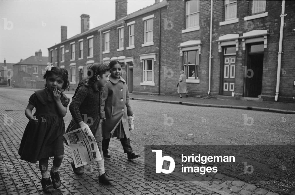 Three girls make their way home, Marshall Street; Smethwick, Black Country, 1964 (b/w photo)