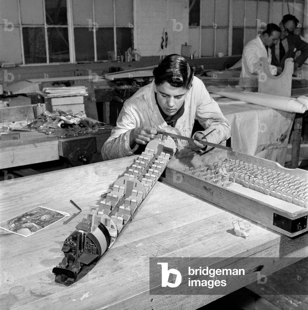 Factory where model aircraft for the travel agents are made. Men making model planes. Circa 1960