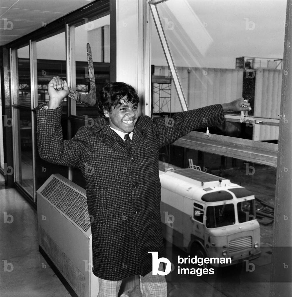 An aboriginy teenager from Australia holding a boomerang. November 1969