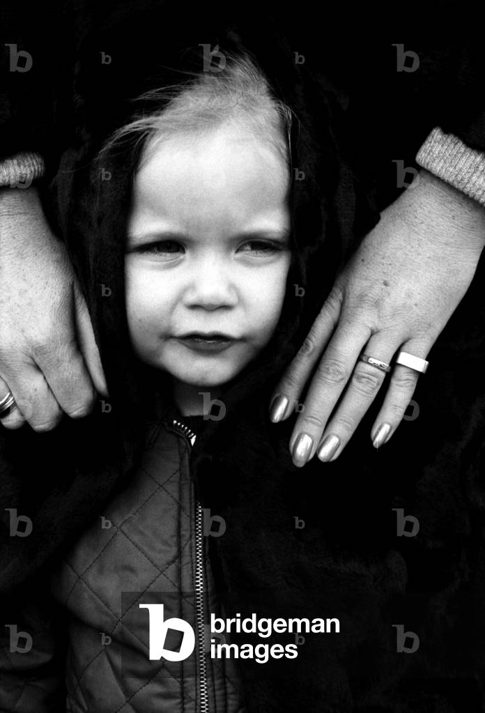 actress Francis Dean who lives in Fairfax Road, N.W.6., wears a maxi-coat and it is made of synthetic fur by astraka. She was out today with daughter Belinda (2) and Belinda found maxis very cosy indeed especially with today's weather. They were waiting for a No. 31 bus where the pictures were taken. November 1969
