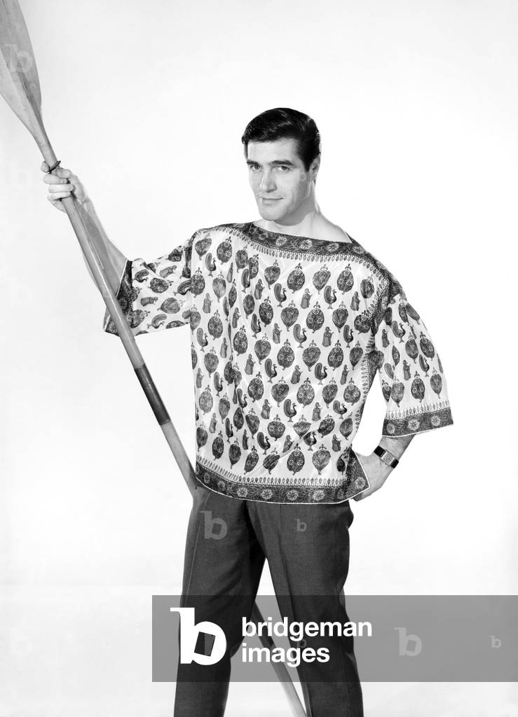 Male model Peter Christian wearing silk shirt seen here holding a oar, c. 1964 (b/w photo)