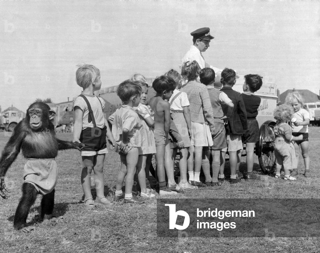 Children queue with their Chimpanzee friend for an ice cream at Billy Smart Circus 1953