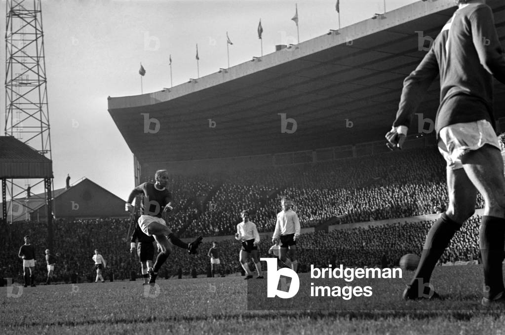 Sport: Football: Manchester United v. Stoke City. With Denis Law standing on the line after having passed back to Charlton, Bobby slams home the ball to score for United. November 1969 (photo)
