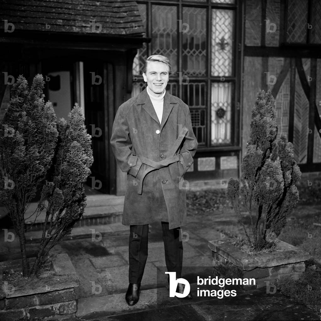 Adam Faith modelling a Canary Yellow pullover and Suede jacket. 13th December 1963 (b/w photo)