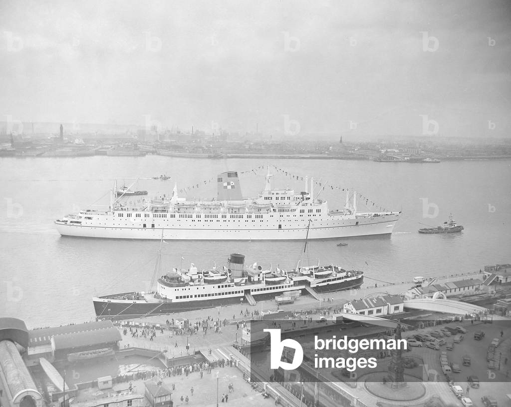 The Empress of Canada seen here being towed to the quayside on the River Mersey at the start of her maiden voyage.27th April 1961 (b/w photo)